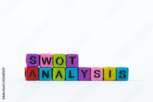 SWOT ANALYSIS text made from colorful beads or letter bead on white background, finance and business concept.