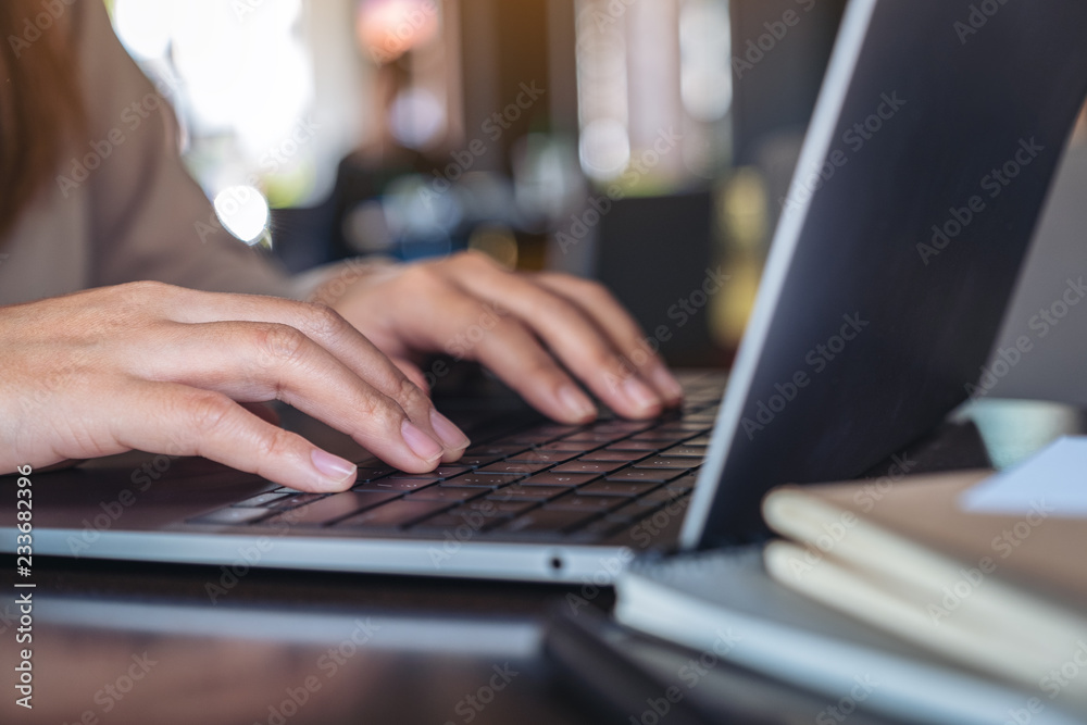 Closeup image of hands using and typing on laptop keyboard Closeup image of hands using and typing on laptop keyboard