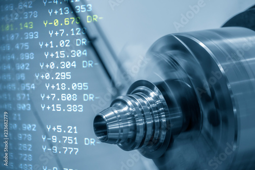 Abstract scene of  CNC lathe or turning machine and NC code data cutting the cone shape .Hi-technology manufacturing process. photo