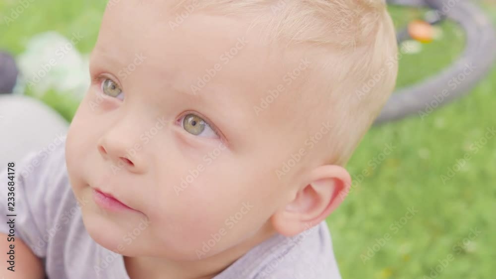 Small boy child standing and running among green grass field of corn or maize sunny day outdoor on natural blue sky and mountain background. Small boy child standing and running among green grass field of corn or maize sunny day outdoor on natural blue sky and mountain background.
