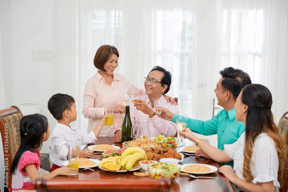 Happy family celebrating birthday of grandfather at home