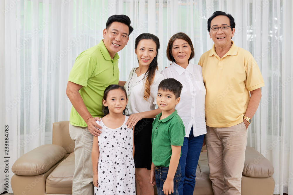 Smiling happy grandparents, parents and children gathered at home Smiling happy grandparents, parents and children gathered at home
