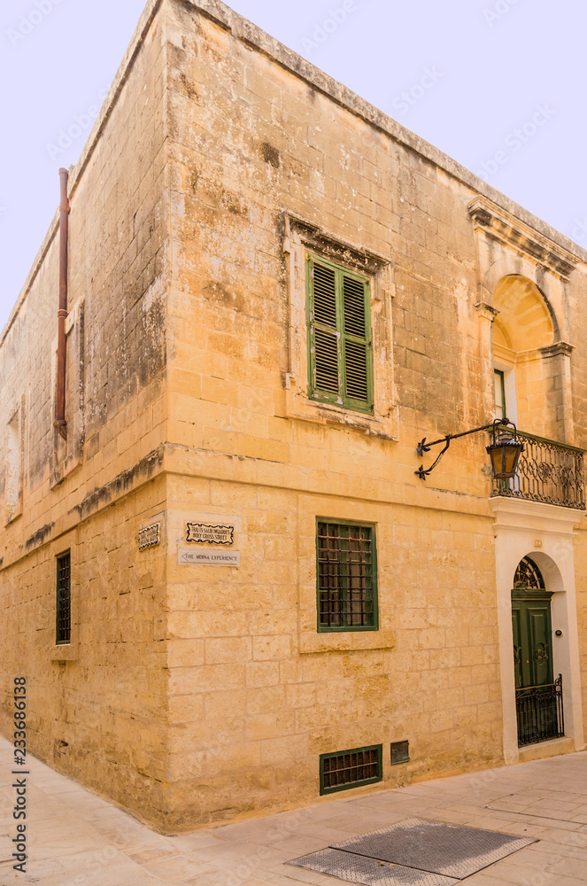 Mdina, Malta. Ancient building at the corner of Holy Cross Street and Aragona Alley