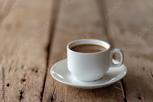 cup of coffee on a wooden table in the morning