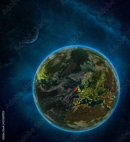 Fototapeta Naklejka Na Ścianę i Meble -  Ireland from space on Earth at night surrounded by space with Moon and Milky Way. Detailed planet with city lights and clouds.