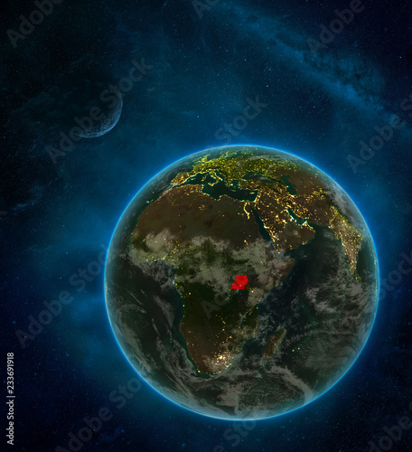 Uganda from space on Earth at night surrounded by space with Moon and Milky Way. Detailed planet with city lights and clouds.