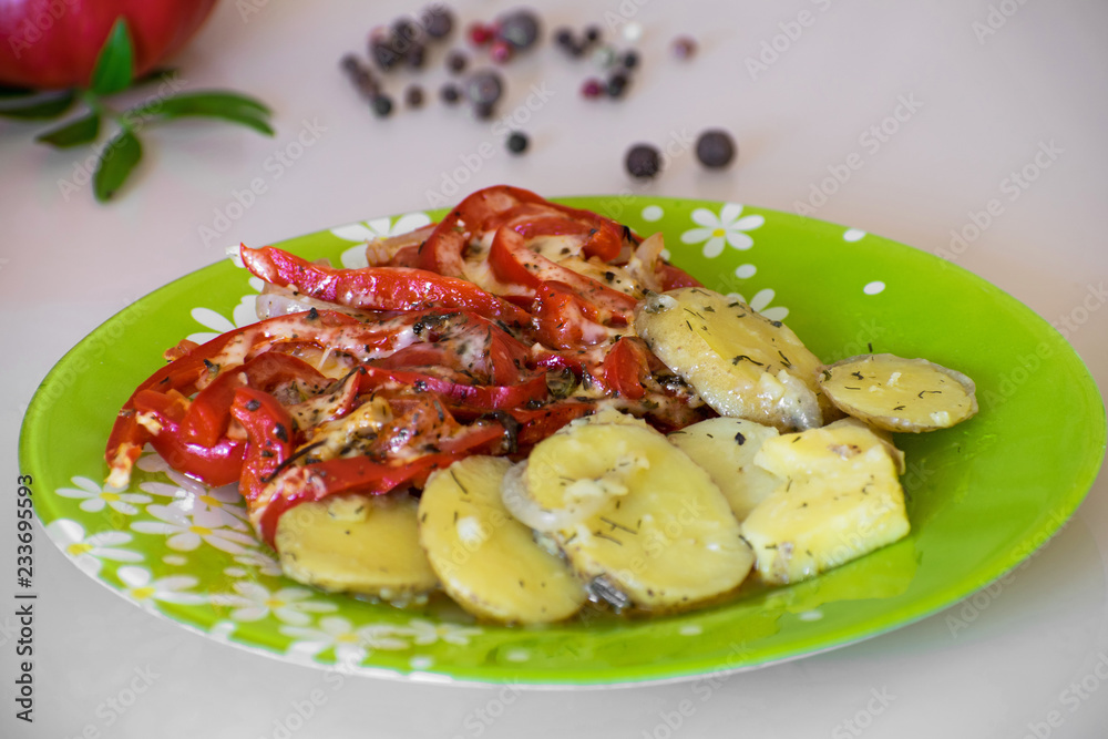 Baked potatoes and vegetables with spices. Stewed potatoes with tomatoes, sweet red pepper and spices. Baked potatoes and vegetables with spices. Stewed potatoes with tomatoes, sweet red pepper and spices.