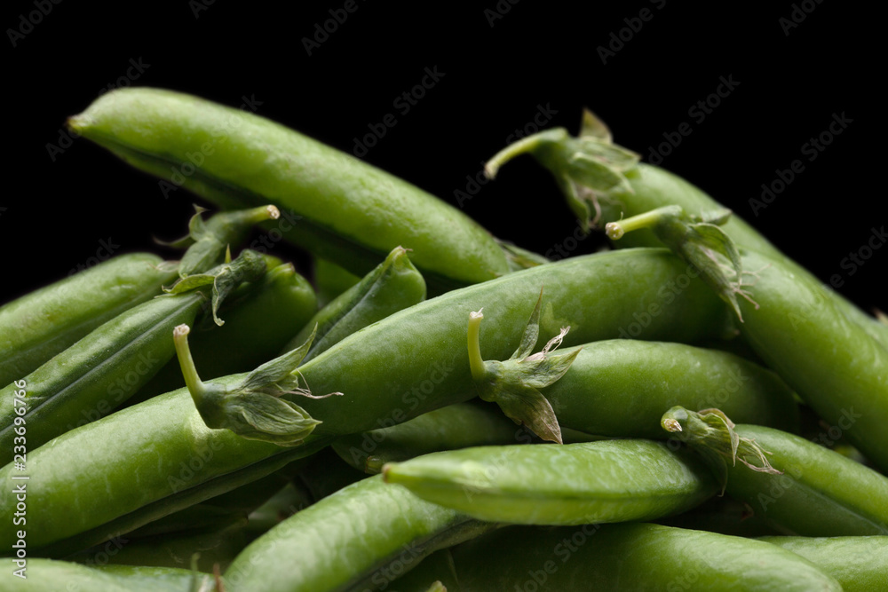 green fresh peas isolated on black background green fresh peas isolated on black background