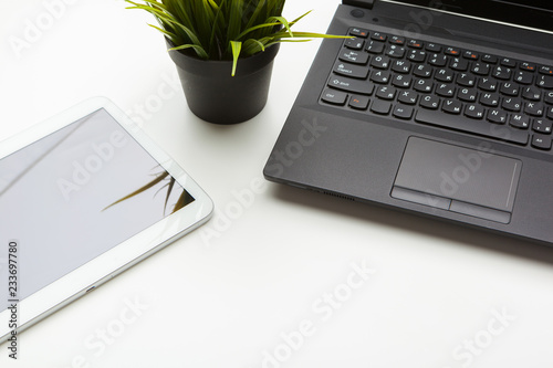 Open laptop with digital tablet on the table