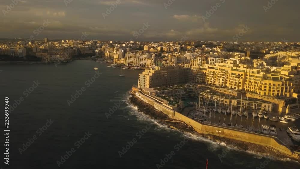 The buildings of San Giljan shine with a golden light from the sunrise