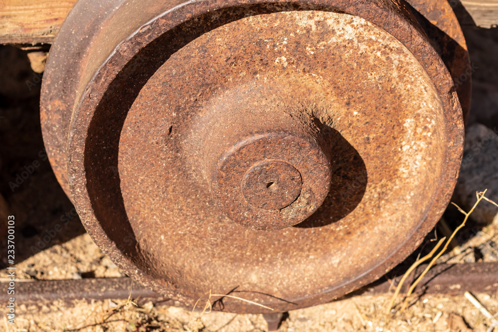 Antique mine cart wheel with deep rusty patina Antique mine cart wheel with deep rusty patina