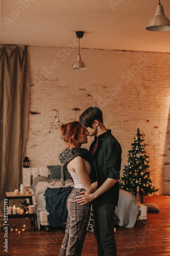 beautiful red-haired girl in the arms of a man