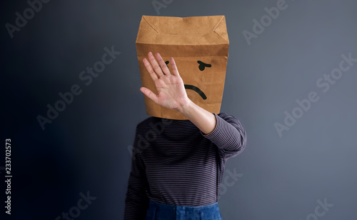 Customer Experience or Human Emotional Concept. Introvert Person. Woman Covered Face by Paper Bag presenting her Sad Feeling by Drawn Line Cartoon and Body Language photo