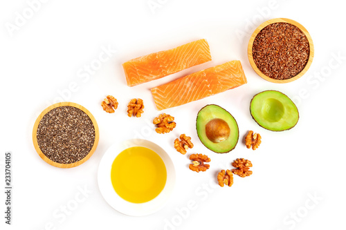 An overhead photo of the ingredients of a healthy omega 3 diet. Salmon, avocado, nuts, chia and flax seeds, shot from the top on a white background with a place for text