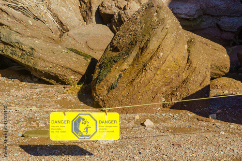 Warning sign regarding rock fall in Hopewell Rocks