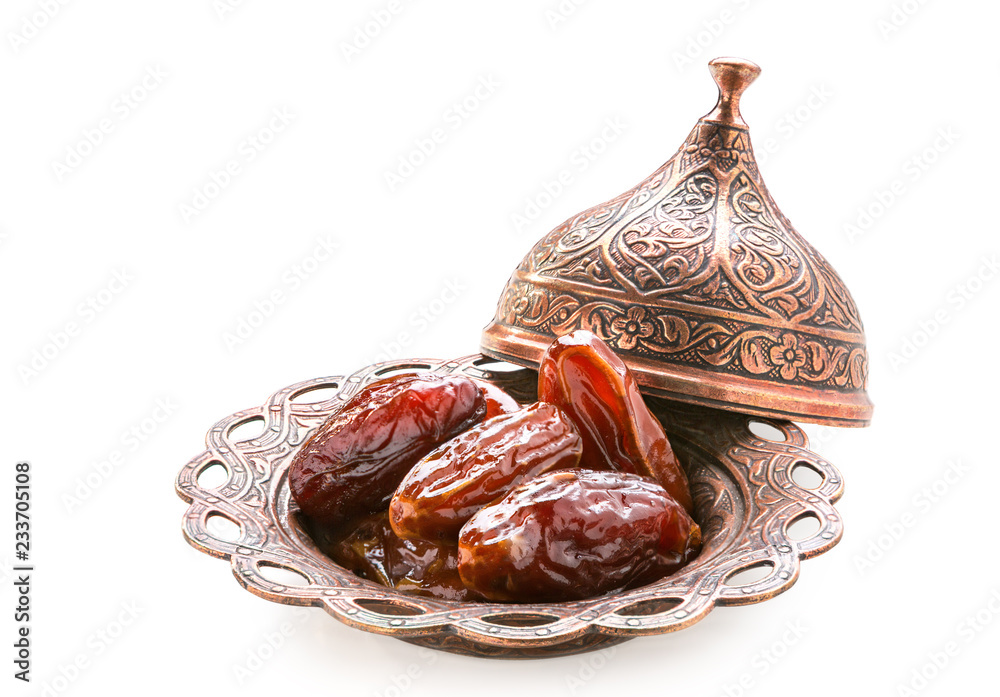 Plate of pitted dates isolated on a white background.