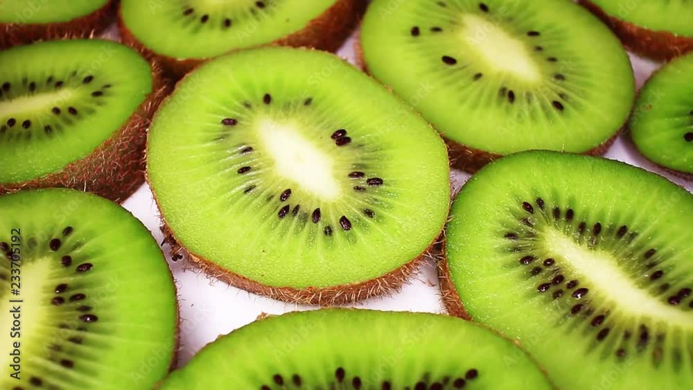 Kiwi slices texture pattern on rotating plate food hd video looping clip Kiwi slices texture pattern on rotating plate food hd video looping clip
