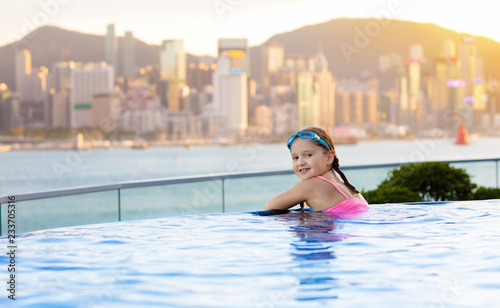 Kids swim in Hong Kong roof top swimming pool