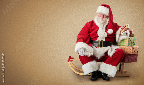 Santa Claus, sled, Christmas gifts and copy space photo