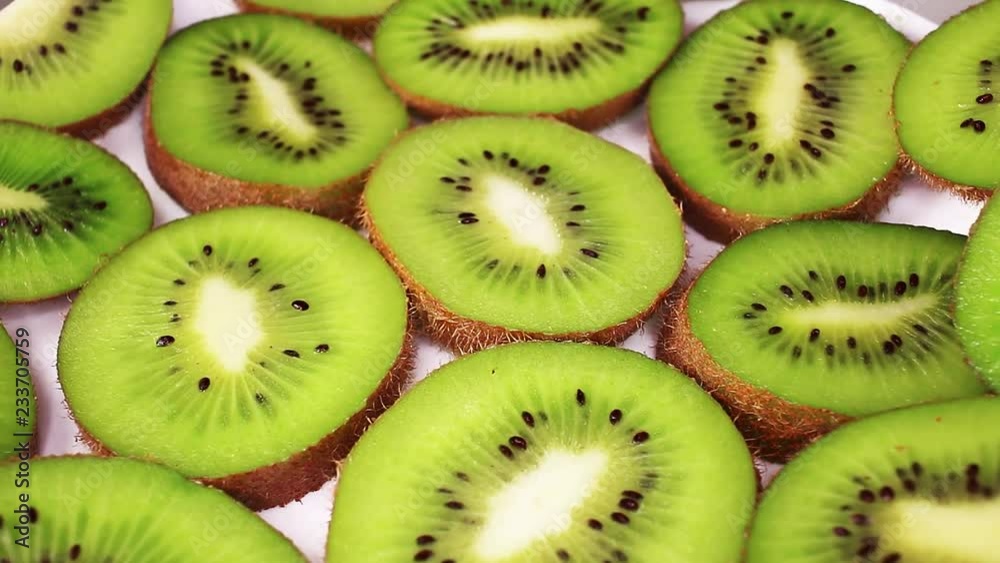 Kiwi slices texture pattern on rotating plate food hd video looping clip Kiwi slices texture pattern on rotating plate food hd video looping clip