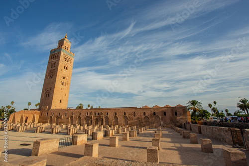 Koutoubia Mosque minaret (Djemma el Fna tower) in old medina of Marrakech, Morocco. Touristic place in Marrakesh used by local people as square or market place.  photo