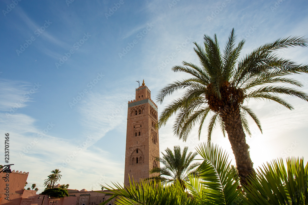 Koutoubia Mosque minaret (Djemma el Fna tower) in old medina of Marrakech, Morocco. Touristic place in Marrakesh used by local people as square or market place. 