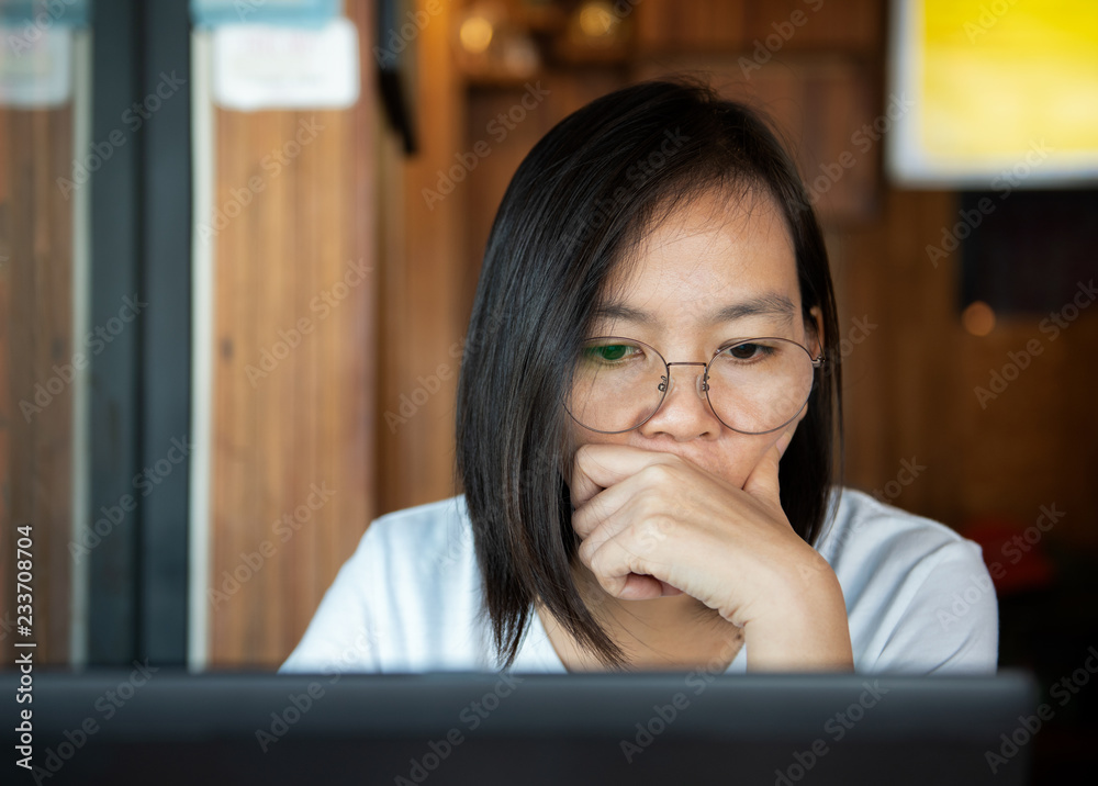 Asian office lady using laptop.She looks seriously. Asian office lady using laptop.She looks seriously.