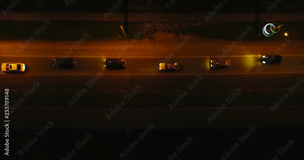 Flying over the roadway with cars at night. Beautiful aerial view on the night road. Flying over the roadway with cars at night. Beautiful aerial view on the night road.