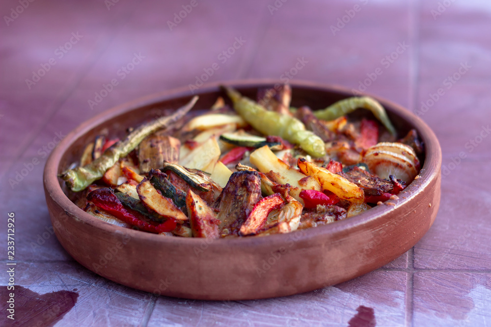 Close-up shoot of onion, pepper, tomato meat meal in the traditional plate Close-up shoot of onion, pepper, tomato meat meal in the traditional plate