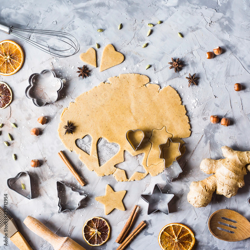 Cooking gingerbread cookies from dough using different forms - heart, star, Christmas tree. Winter home baking. Preparing for christmas concept. Top view photo