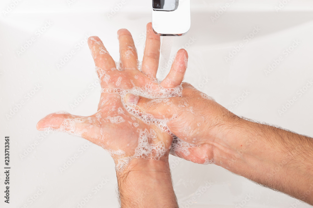 Fototapeta premium Close-up of man cleaning hands.