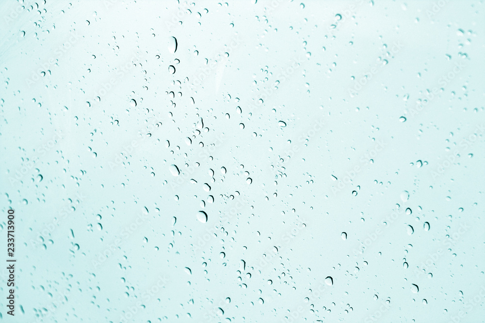 Blured water drops on window in cyan tone. Blured water drops on window in cyan tone.