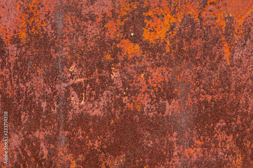 Rusty yellow-red textured metal surface. The texture of the metal sheet is prone to oxidation and corrosion. Textured background in grunge Style