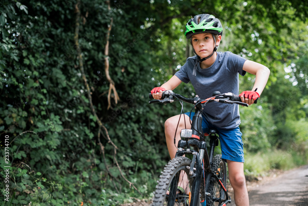 Fototapeta premium A young boy riding his bike