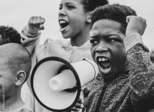 Young boy shouting on a megaphone in a protest photo