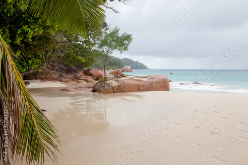 Tropical beach on a cloudy day on Praslin, Seychelles.