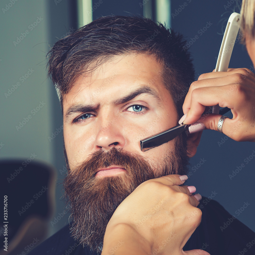 Beard styling and cut. Hipster client visiting barber shop ...