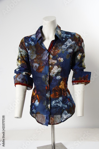 Blue floral blouse shirt on tailor´s dressmaker´s dummy in front of white background