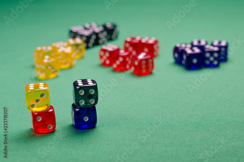 many multi-colored cubes lie on the green table