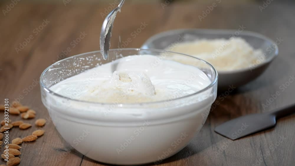 Add almond flour to the batter. Making macaron batter. Add almond flour to the batter. Making macaron batter.