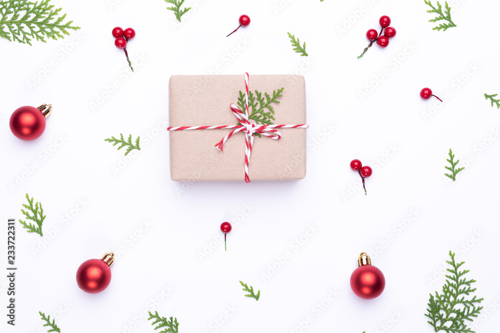 Christmas background concept. Top view of Christmas gift box red sock with spruce branches, pine cones, red berries and bell on white background. Christmas background concept. Top view of Christmas gift box red sock with spruce branches, pine cones, red berries and bell on white background.