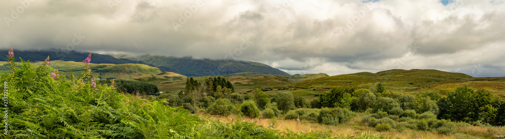 panorama of glen land with blue sky and clouds