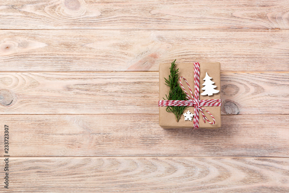 Christmas gift box wrapped in recycled paper, with ribbon top view with copy space on rustic background. Holiday concept Christmas gift box wrapped in recycled paper, with ribbon top view with copy space on rustic background. Holiday concept