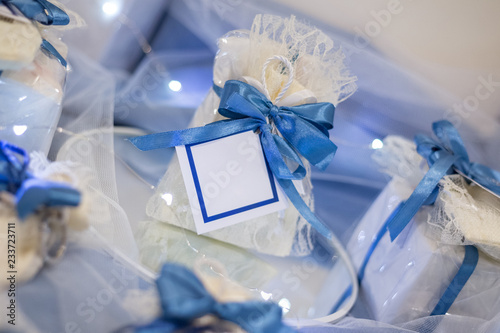 Wedding favor decorated with lace and blue ribbon with message in a bottle with white labels ready to personalize with your text photo