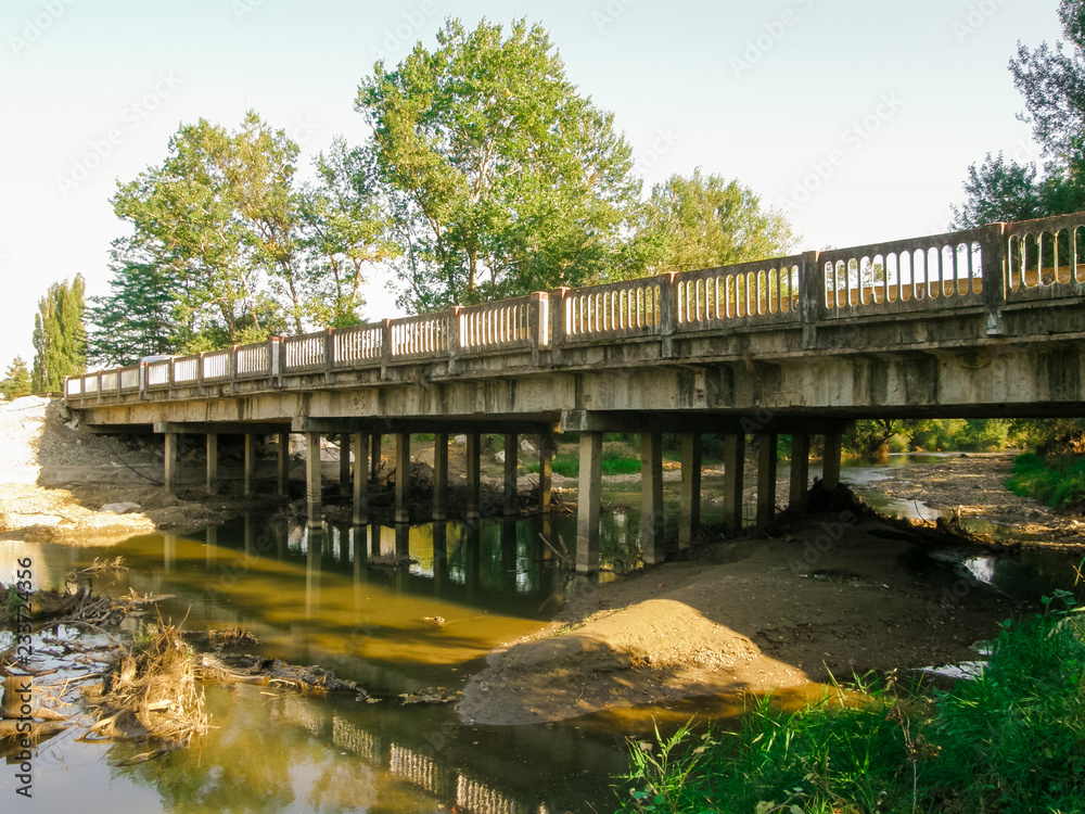 Bridge over the shallow and dirty river