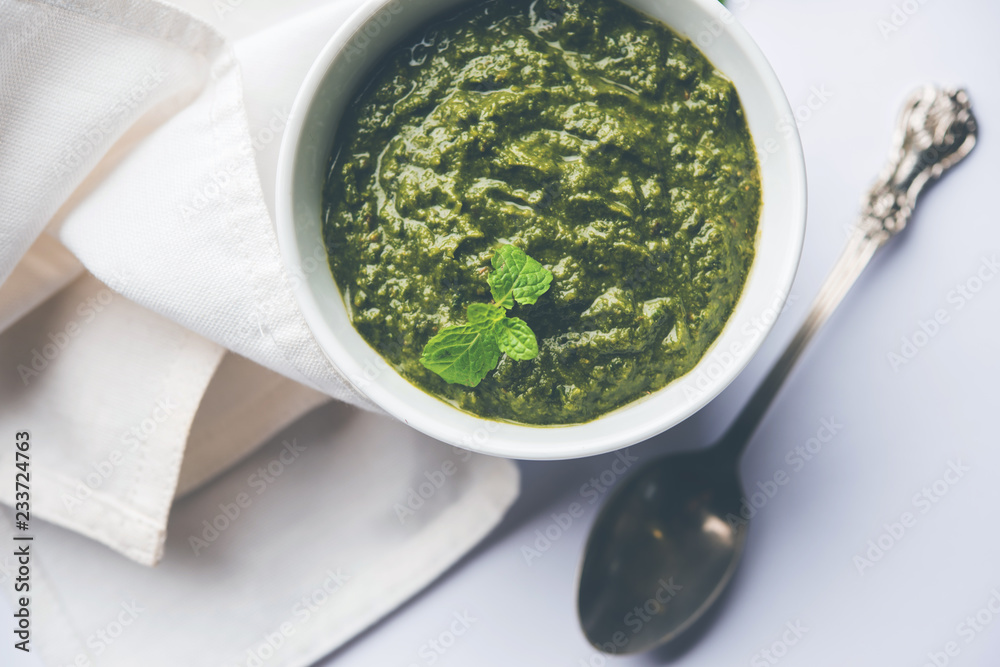 Healthy Indian Green Chutney or Sauce Made using Coriander, Mint And Spices. isolated over moody background. Selective focus Healthy Indian Green Chutney or Sauce Made using Coriander, Mint And Spices. isolated over moody background. Selective focus