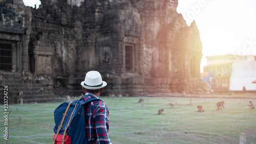 Senior man Asian with backpack are walking at Phra Prang Sam Yot. Ancient and historical attractions and one of the most important archaeology of Lopburi province thailand. Travel, Tourist Concept