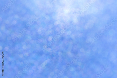 Blurred blue sparkles, soft and abstract full frame background.
