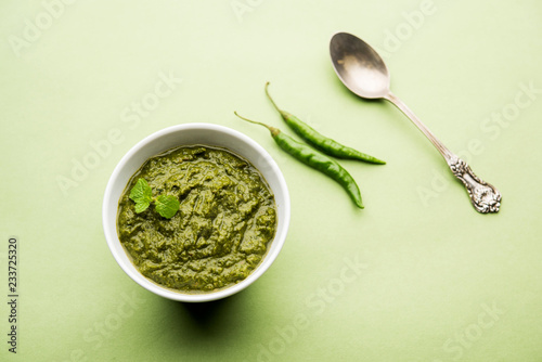 Healthy Indian Green Chutney or Sauce Made using Coriander, Mint And Spices. isolated over moody background. Selective focus