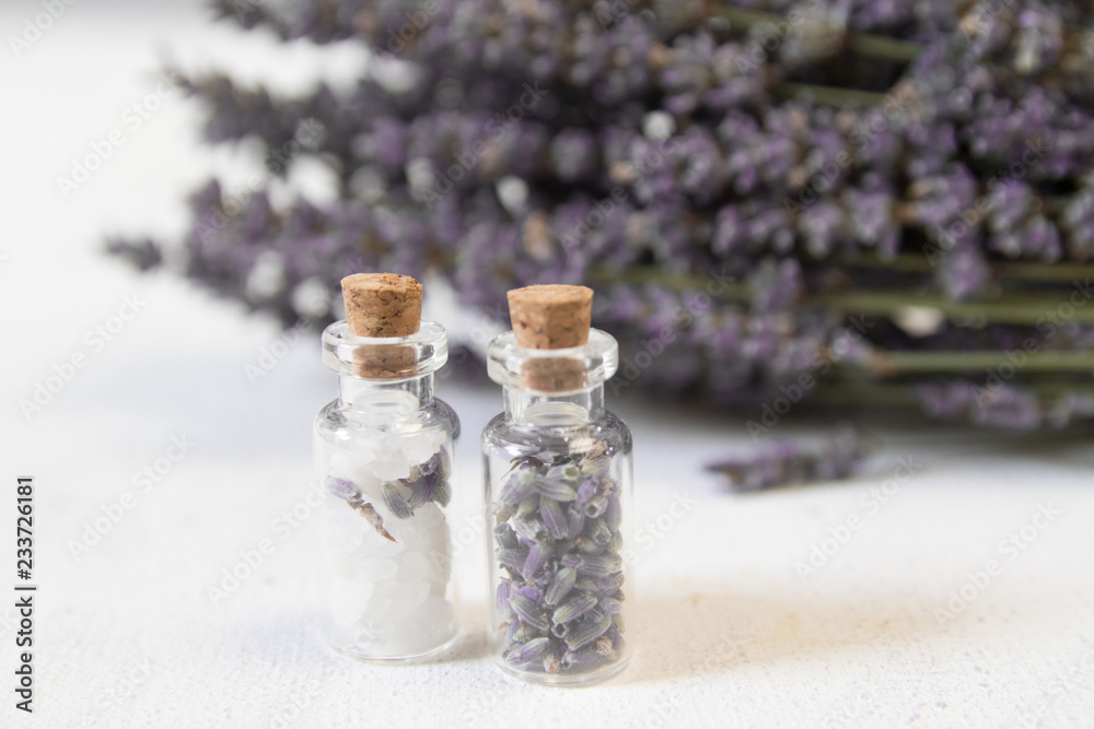 Natural herbal sea salt with aromatic lavender - perfect for relaxation. Cosmetic jars and bottles with salt, lavender flowers, bath bomb Natural herbal sea salt with aromatic lavender - perfect for relaxation. Cosmetic jars and bottles with salt, lavender flowers, bath bomb